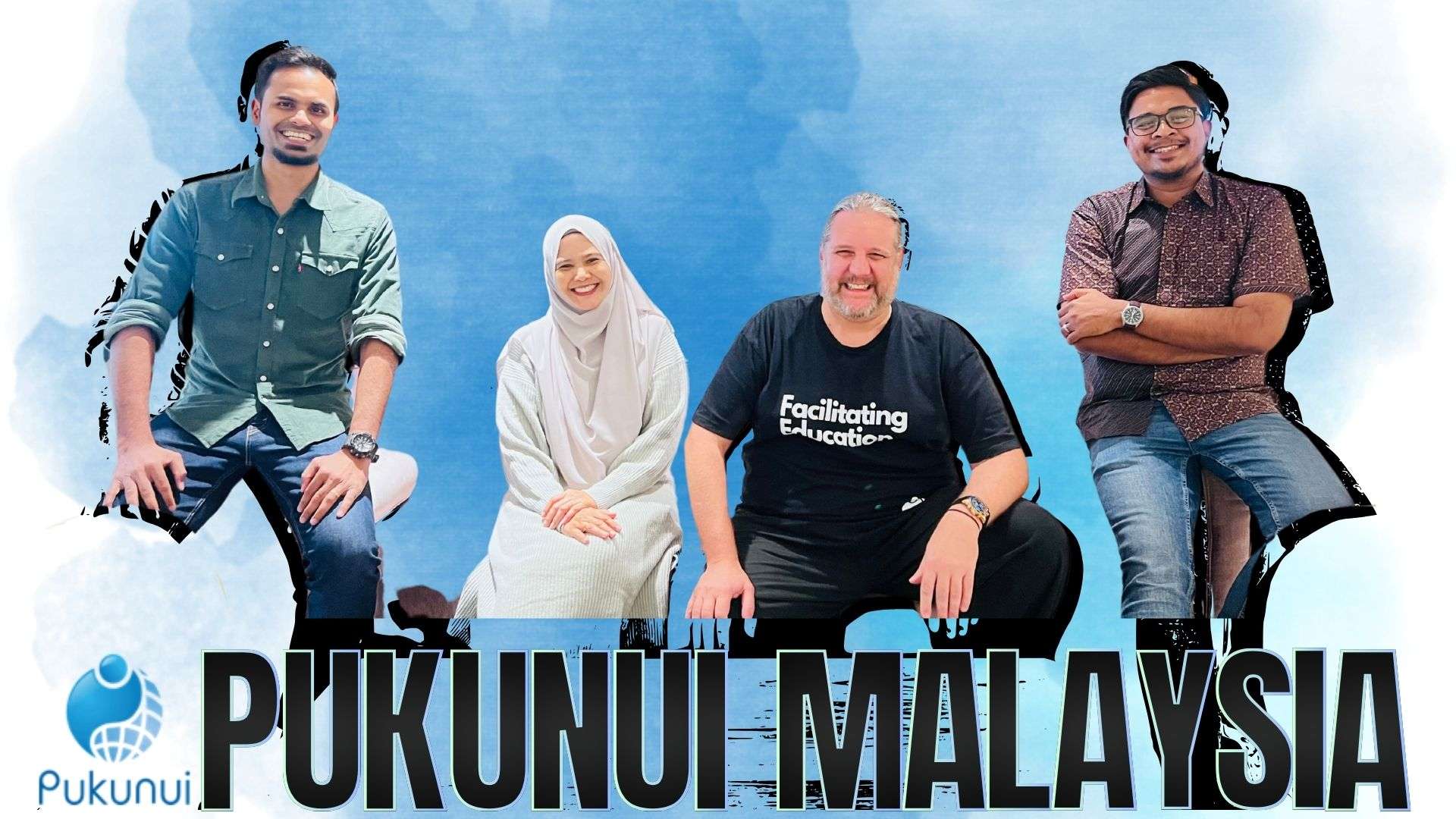 Team members posing together against a blue background