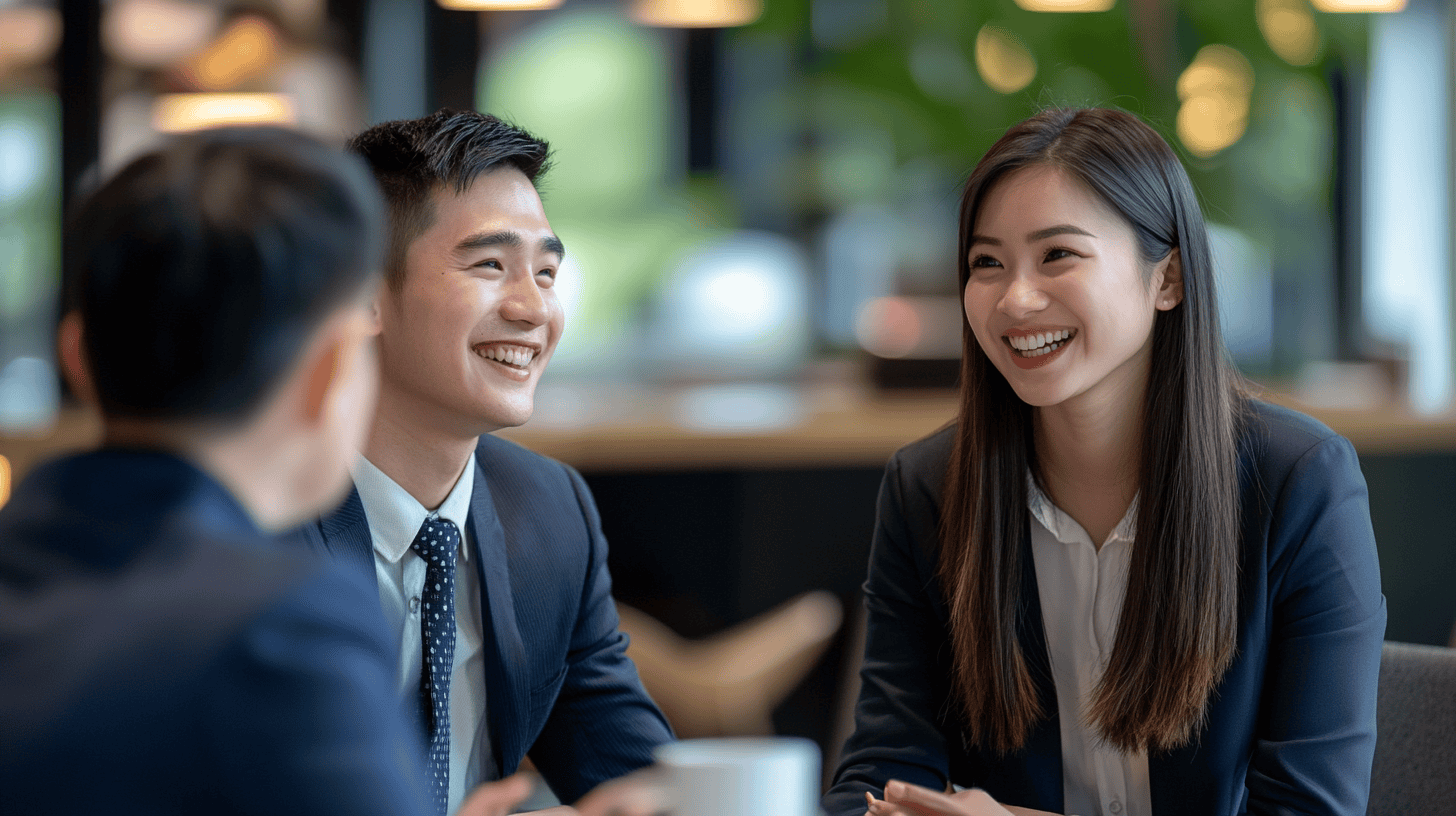 Two professionals engaging in conversation in a modern business setting.