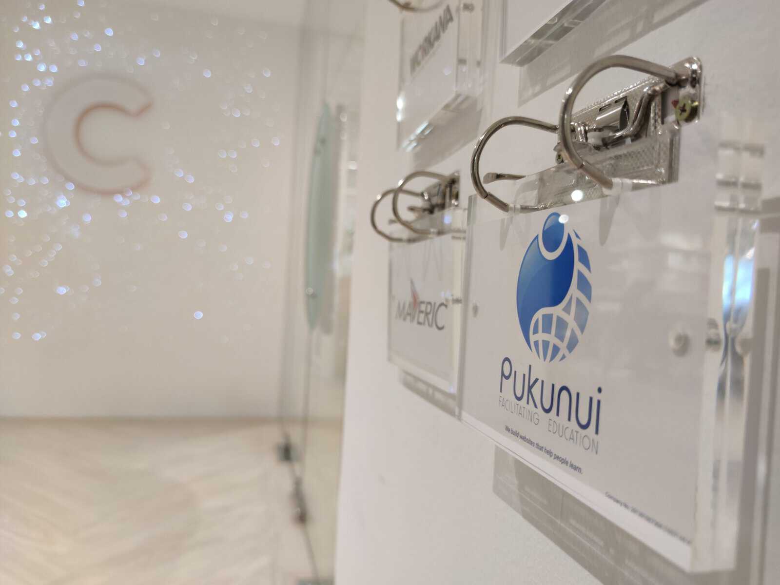 Close-up of a company sign with a logo on a wall